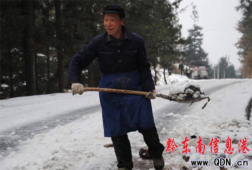 雪凝公路上一個老人忙碌的身影(圖)